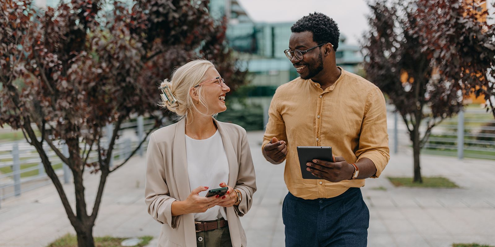 Man and woman walking on sidewalk