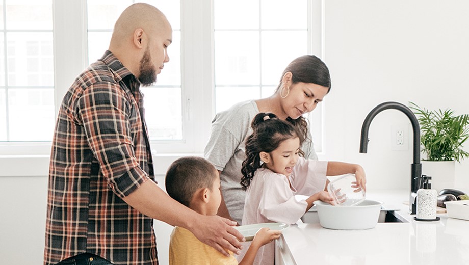 Family of 4 washing dishes