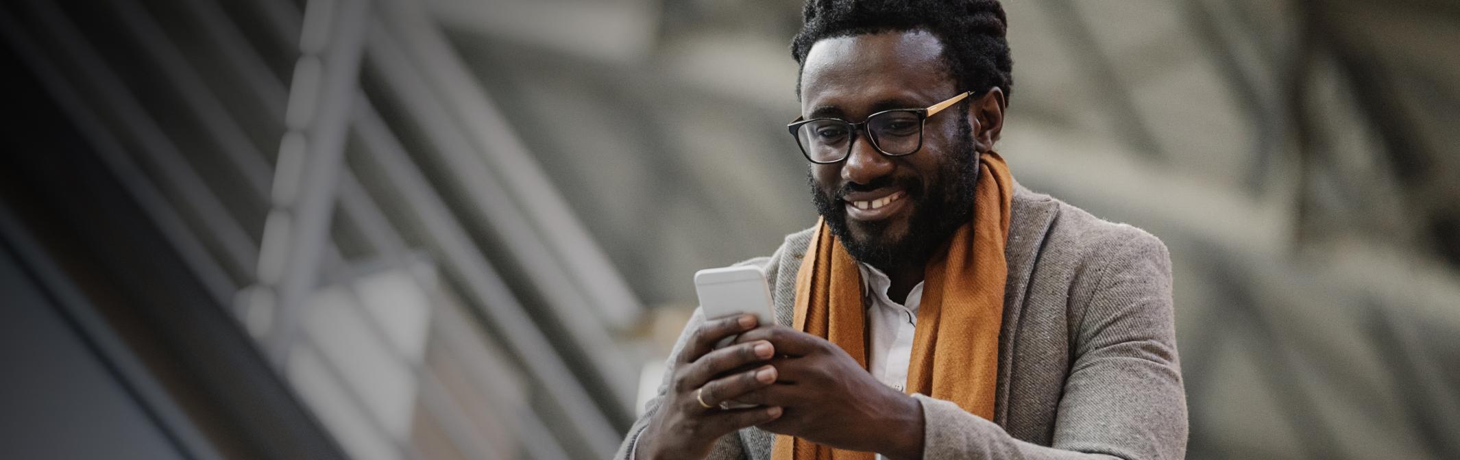 Young man glancing at mobile phone