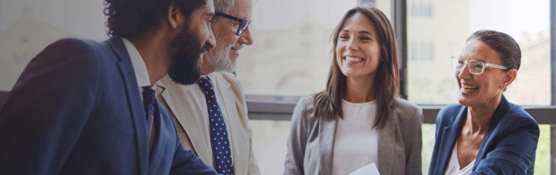 Men and women smiling in a meeting